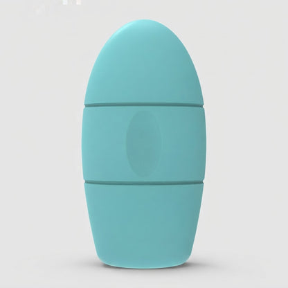 A light blue-green silicone personal massager with a rounded, egg-shaped design and a central oval button, shown on a neutral light gray background.
