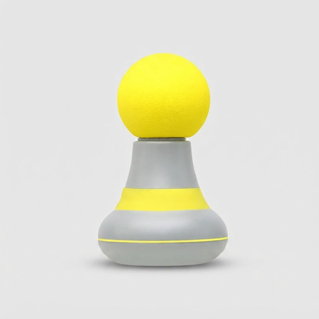 A modern, minimalist personal massager with a textured yellow spherical head and a gray base featuring a yellow accent band, set against a solid light gray background.