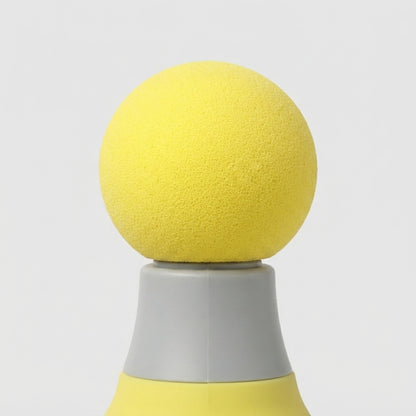 A close-up of a yellow textured spherical object resting on a gray and yellow conical base against a light gray background.